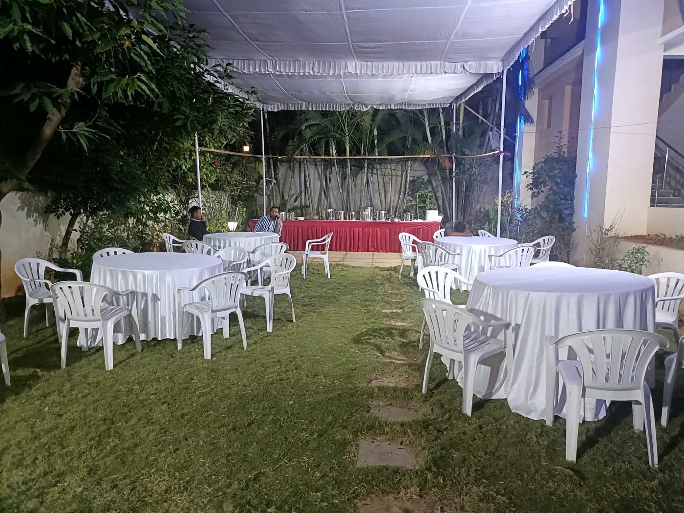 Garden seating with round tables set for an evening event