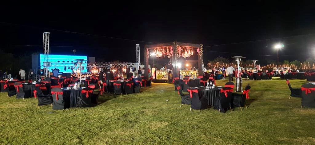 Outdoor night event with styled black and red table settings